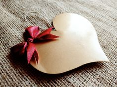 a heart shaped dish with a red bow on it