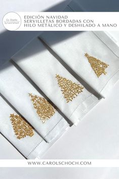 four napkins with gold designs on them sitting next to each other in front of a white background