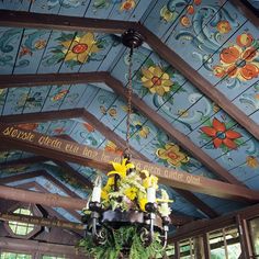 a chandelier hanging from the ceiling in a room with painted walls and ceilings