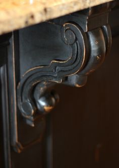 a close up of an ornately decorated table with marble top and metal base,