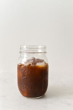 a jar filled with liquid sitting on top of a table