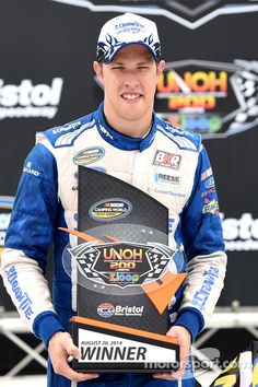 a man holding up a plaque in front of him