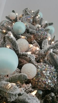 a decorated christmas tree with blue and white ornaments