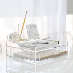 a clear desk with a pen and paper on it