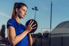 a woman holding a black frisbee in her hands