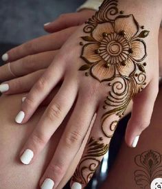 two hands with henna tattoos on them