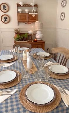 the table is set with dishes and place settings for two people to sit down at