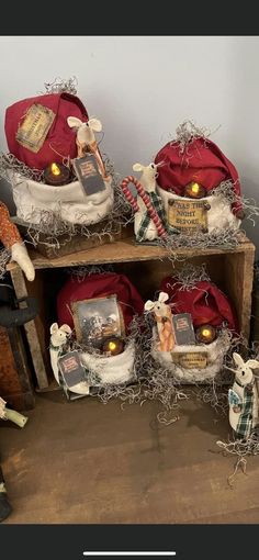 three wooden shelves with santa hats and other items on top of them, all decorated in tinsel