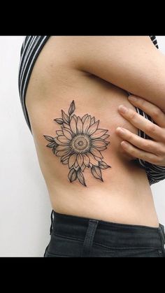 a woman with a sunflower tattoo on her stomach