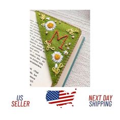 an image of a book with flowers on it and the words next day shipping written in red, white, and blue