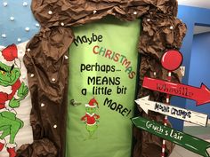 the grinch door is decorated with christmas signs and paper mache on it's side