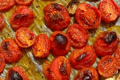 sliced tomatoes on a baking sheet ready to be cooked in the oven for roasting