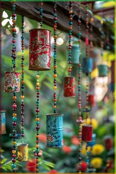 colorful tin can wind chimes hanging from a tree