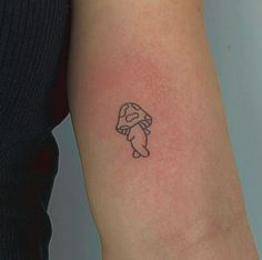 a small tattoo on the arm of a woman's left arm, with an outline of a rabbit