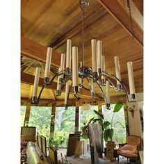 a large chandelier hanging from the ceiling in a room with wood paneling