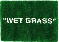 the word wet grass written in white letters on a green area rug that looks like it is