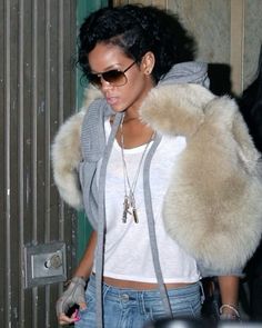 a woman wearing sunglasses and a fur coat