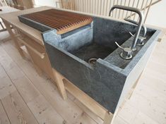 a kitchen sink sitting on top of a wooden floor