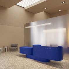 an empty waiting room with blue counter and chairs