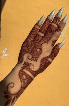 a woman's hand with henna on it