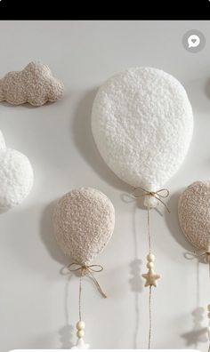 three hot air balloons hanging from strings on the wall with stars and beads attached to them