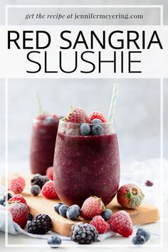 red sangria slushie with raspberries and blueberries on the side