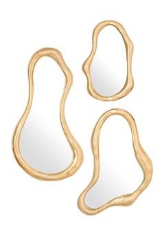 three gold mirrors with curved shapes