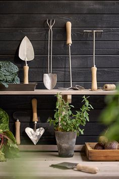 an assortment of gardening tools and vegetables on a table