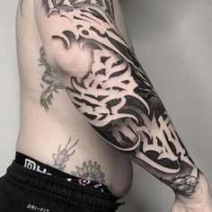 a man's arm with tattoos on it