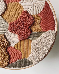 a close up of a circular rug with different colors and shapes on it's surface