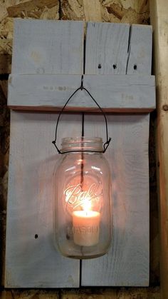 a mason jar with a candle hanging from it