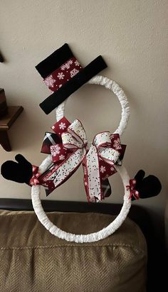 a christmas decoration made out of fabric and bows on the headbands is displayed in front of a wall