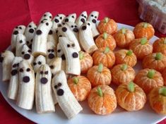 there are many peeled bananas and oranges on the plate with chocolate eyes painted on them