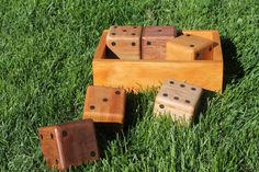 four wooden dices are in the grass with one on it's side and two on its back