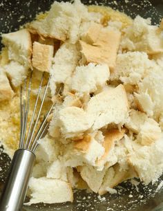 a bowl filled with bread and some whisk in it