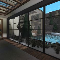 a room with glass walls and trees outside the window, in front of an indoor swimming pool