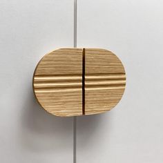 a wooden object hanging on the side of a wall