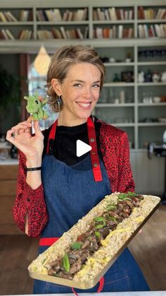 a woman holding a tray with food on it