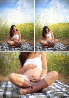 a pregnant woman sitting on top of a blanket next to a field with yellow flowers