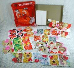 the contents of a valentine's day gift box are laid out on a bed