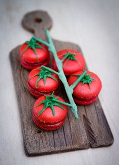 small red tomatoes on a wooden cutting board