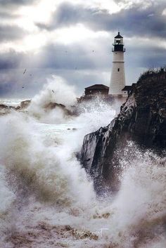 a lighthouse surrounded by waves in the ocean