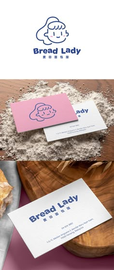 bread lady logo and business card on a wooden table with pink paper next to it