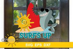 a wooden sign that says surfs up with a shark and sun on the window sill