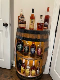 an old wooden barrel filled with liquor bottles