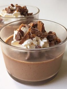 two desserts with chocolate, marshmallows and whipped cream in small bowls