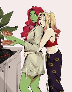 two women standing next to each other near a stove top oven and potted plant