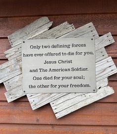 a sign on the side of a building that says only two defined forces have ever offered to tie for you jesus christ and the american soldier one died for your soul