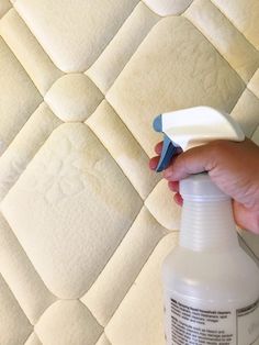 someone is using a spray bottle to clean mattresses