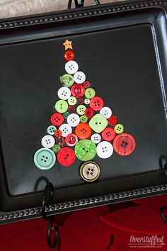 a christmas tree made out of buttons on a tray